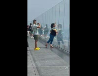 Woman black shirt hug glass rooftop NYC