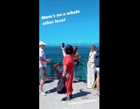 Woman red outfit films scenery on cruise