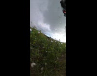 Rider on green motorbike flies off bike