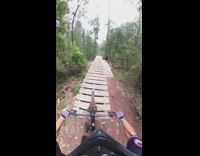 Man Drops off Ramp and Traverses Trail