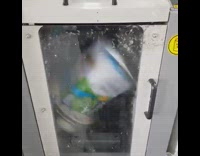 Can of paint mixed inside the machine mixer