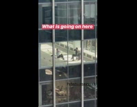 Two people hug themselves on empty floor tall business building