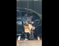 Collab IITW - Woman in leather jacket bend over and twerks on the side of the car