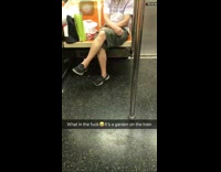 man hangs green onions on subway