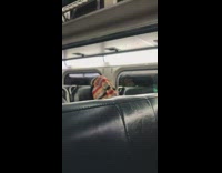 Striped blanket over face bus black seats