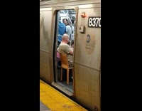 Old man brings his own chair to the subway