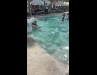 Couple play and piggyback ride pool lifeguard