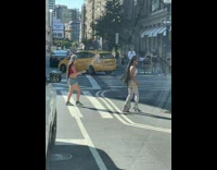 Woman in patterned dress walks on the pedestrian lane