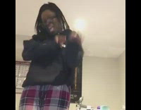 Girl in red plaid pajama pants dances to song and falls on the floor