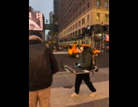 DJ plays music while walking on street