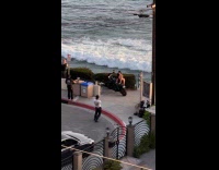 Woman bikini poses beside motorcycle near beach