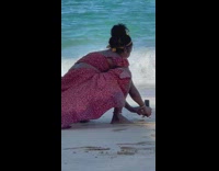 Woman red beach dress take pictures of beer can beach