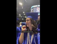 Girl starts cap toss at high school graduation 