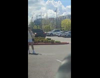 Woman in a yellow jacket poses with a drink