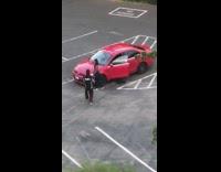 Girl pose beside red car parking lot