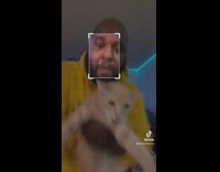 Guy holding cat uses moving box filter 