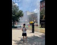 Boy pose with pipe burst roadwork behind