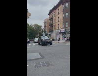 Skeleton wearing shirt sticks out of car 