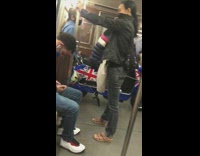 Guy sits blue union jack scooter subway 