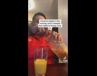 Guy pours a glass of orange juice and then pours tequila in