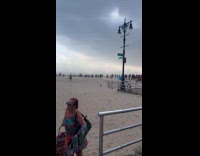 Crowd evacuating from beach because of sandstorm