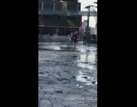 Woman black dress walk ground water fountain