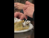 Guy eats a cake with a tamale