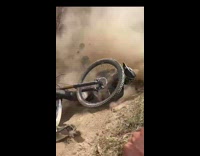 Person rides mountain dirt bike track and falls