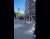 Women traffic cone head walk street hold rope