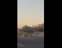 Couple lays on ground for drone photo 