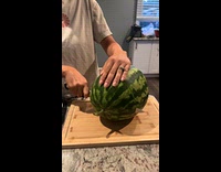 Woman cuts watermelon that is not yet ready