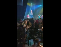 Woman phone lights selfie during band concert