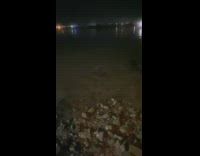 Person throw rock at water bioluminescent planktons