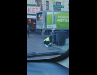 Woman green jacket selfie timer garbage bin