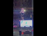 Guy dance on top of the big screen at street NYC 