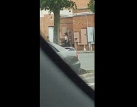 Two girls dance alley red brick walls
