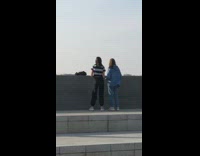 Two girls tiktok cement steps striped shirt 