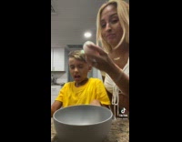 Mom cracks egg on sons forehead 