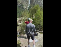Woman red jacket drink water photo shoot mountain