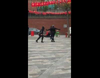 Two people all black dancing chinese lanterns