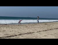 Red pants lady yoga pose beach sand 