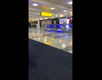 Woman raise feet balance walkalator airport tripod