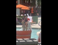Three women in bikini poses at pool