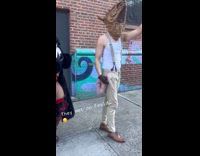 Guy dressed as rat walks on street