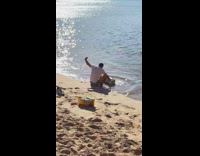Guy takes selfie on beach with printer 