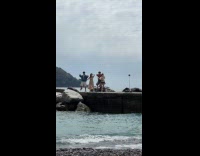 Four people tiktok dance at beach dock