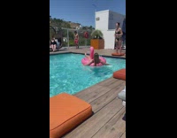 Woman lay on pink flamingo floaty pool