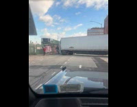 Tractor trailer truck turning blocks the street
