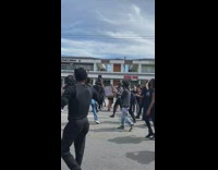 Peaceful protest guy throws money white car