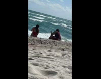 Woman red swimsuit sit on beach sunny